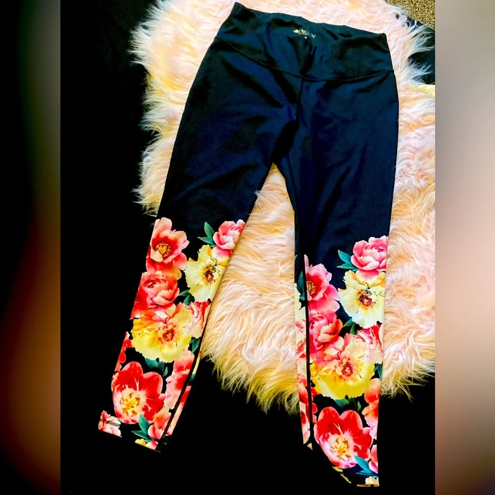 These are black leggings with pink and yellow flowers, Ideology, size Medium. - Picture 1 of 4